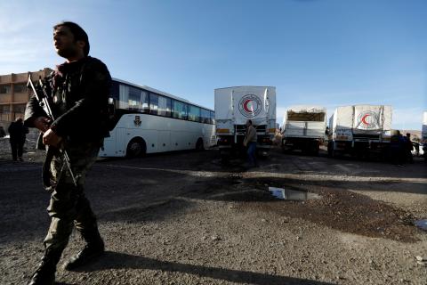 A Syrian soldier secures aid convoy after its return from eastern Ghouta in Damascus, Syria, March 9, 2018. PHOTO BY REUTERS/Omar Sanadiki