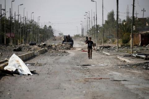A member of Iraqi counterterrorism forces walks with his weapon. PHOTO BY REUTERS/Thaier Al-Sudani