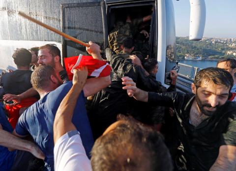Soldiers push each other to board a bus to escape the mob after troops involved in the coup attempt surrendered on the Bosphorus Bridge in Istanbul, Turkey, July 16, 2016. PHOTO BY REUTERS/Murad Sezer
