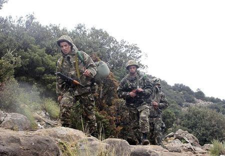 Soldiers arrive at the site of a military plane crash near the village of Ouled Gacem in eastern Algeria, about 500km (311 miles) from the capital Algiers, February 12, 2014. PHOTO BY REUTERS/Louafi Larbi