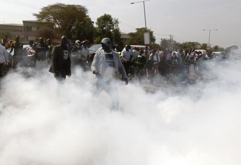 Students from Langata primary school and activists run from teargas fired by riot police during a protest against a perimeter wall erected by a private developer around their school playground in Kenya's capital Nairobi, January 19, 2015. PHOTO BY REUTERS/Thomas Mukoya