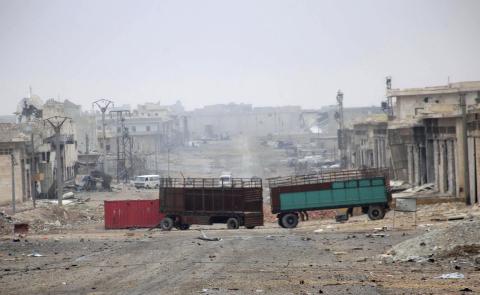 Damaged buildings and vehicles are pictured along a deserted street in the Aleppo town of Naqaren, after forces loyal to Syria's President Bashar al-Assad claimed to have regained control of the town