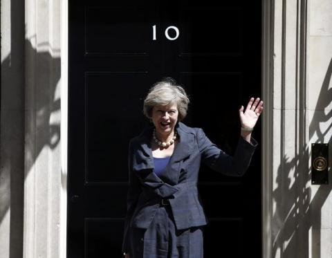 Britain's Home Secretary Theresa May, who is due to take over as prime minister on Wednesday, waves as she leaves after a cabinet meeting at number 10 Downing Street, in central London, Britain, July 12, 2016. PHOTO BY REUTERS/Peter Nicholls