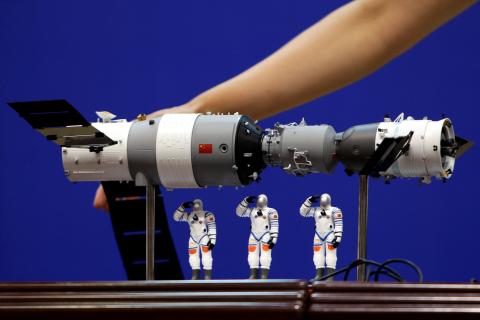 A model of the Tiangong-1 space lab module (L), the Shenzhou-9 manned spacecraft (R) and three Chinese astronauts is displayed during a news conference at Jiuquan Satellite Launch Center, in Gansu province, China, June 15, 2012. PHOTO BY REUTERS/Jason Lee