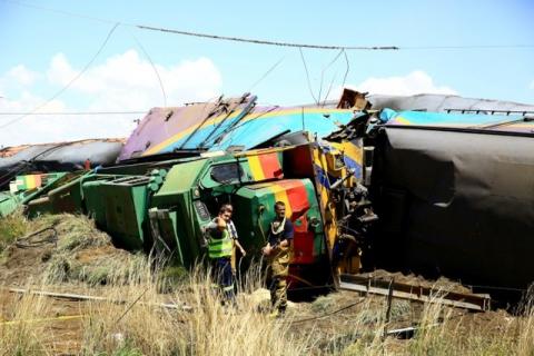 Workers stand next to a wreckage after a train crash near Hennenman in the Free State province, South Africa, January 4, 2018. PHOTO BY REUTERS/Stringer