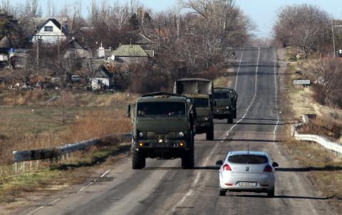 Military trucks are seen through a car window as they drive along a road on the territory controlled by the self-proclaimed Donetsk People's Republic in Bezimenne, eastern Ukraine, November 22, 2014. PHOTO BY REUTERS/Antonio Bronic