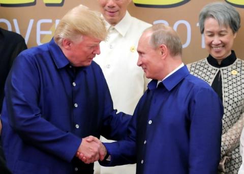 U.S. President Donald Trump and Russian President Vladimir Putin shake hands as they take part in a family photo at the APEC summit in Danang, Vietnam, November 10, 2017. PHOTO BY REUTERS/Sputnik/Mikhail Klimentyev/Kremlin