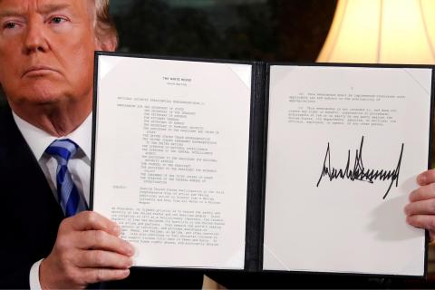 U.S. President Donald Trump holds up a proclamation declaring his intention to withdraw from the JCPOA Iran nuclear agreement after signing it in the Diplomatic Room at the White House in Washington, U.S. May 8, 2018. PHOTO BY REUTERS/Jonathan Ernst