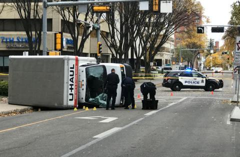 Edmonton Police investigate at the scene where a man hit pedestrians then flipped the U-Haul truck he was driving, pictured at the intersection at 107 Street and 100th Avenue in front of the Matrix Hotel in Edmonton, Alberta, Canada, October 1, 2017. PHOTO BY REUTERS/Candace Elliott
