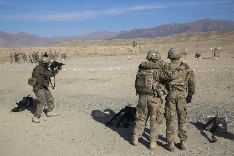 U.S. soldiers from the 3rd Cavalry Regiment watch a member of the Polish military on a shooting range as part of a joint training mission, near forward operating base Gamberi in the Laghman province of Afghanistan, December 12, 2014. PHOTO BY REUTERS/Lucas Jackson