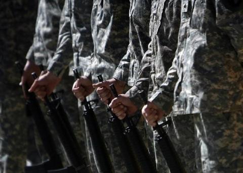 U.S. soldiers hold thier rifles during a Memorial Day observance ceremony at the Bagram airbase, north of Kabul. PHOTO BY REUTERS/Ahmad Masood