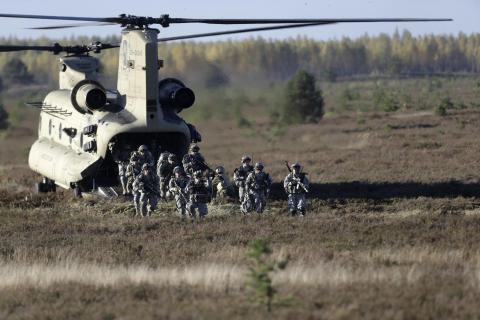 Members of the U.S. Army's 173rd Airborne Brigade Combat Team leave a Chinook helicopter during the Silver Arrow NATO military exercise in Adazi, Latvia