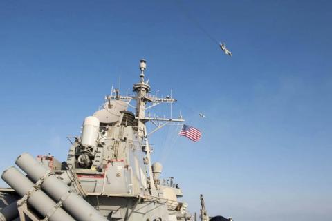 What appears to be a Russian Sukhoi SU-24 attack aircraft is flying over the U.S. guided missile destroyer USS Donald Cook in the Baltic Sea, April 12, 2016. PHOTO BY REUTERS/US Navy