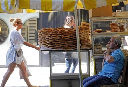A vendor of local pastries waits for clients in central Athens, Greece, July 6, 2015. PHOTO BY REUTERS/Jean-Paul Pelissier