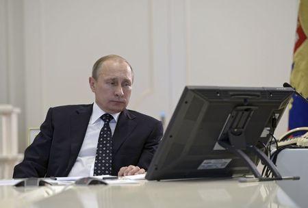 Russian President Vladimir Putin attends a video conference dealing with the commissioning of military products at the Kremlin's Command Center in Moscow, Russia, July 16, 2015. PHOTO BY REUTERS/Alexei Nikolsky