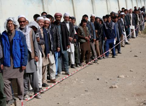 Afghan men line up to cast their votes during the parliamentary election at a polling station in Kabul, Afghanistan, October 21, 2018. PHOTO BY REUTERS/Omar Sobhani