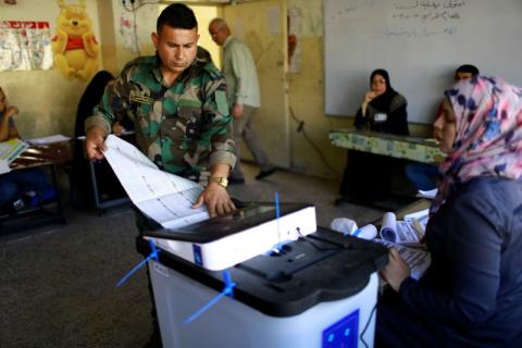 An Iraqi security member casts his vote at a polling station two days before polls open to the public in a parliamentary election in Baghdad, Iraq, May 10, 2018. PHOTO BY REUTERS/Thaier al-Sudani