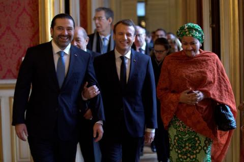 French President Emmanuel Macron walks between Lebanon's Prime Minister Saad al-Hariri and UN Deputy Secretary General Amina Mohammed as they arrive to attend the Lebanon International Support Group meeting in Paris, France, Decdember 8, 2017. PHOTO BY REUTERS/Philippe Wojazer