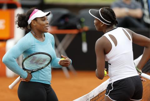 Serena Williams (L) of the U.S. talks with her sister Venus during a training session ahead of the first round of their Fed Cup World Group II tennis match against Argentina, in Buenos Aires, February 5, 2015. PHOTO BY REUTERS/Enrique Marcarian