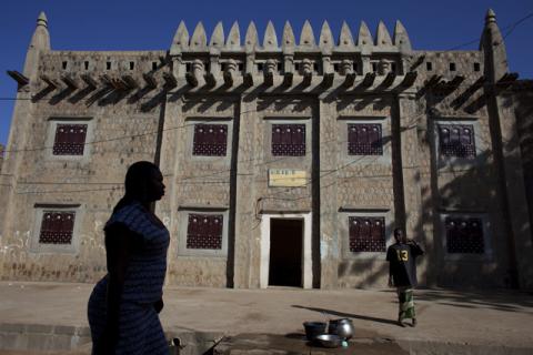 A woman walks by an Islamic institute in traditional Moorish style in Djenne, Mali, September 1, 2012. PHOTO BY REUTERS/Joe Penney