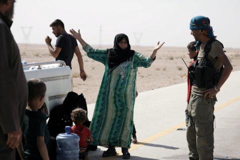A Syrian woman reacts after she removes the niqab as she arrives with her family at the Syrian Democratic Forces (SDF) check point in the eastern of Deir al Zor, Syria, September 12, 2017. PHOTO BY REUTERS/Rodi Said