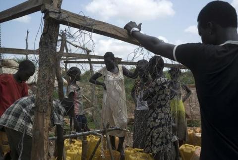 South Sudanese women collect water in the United Nations protection of civilians site hosting about 30,000 people displaced during the recent fighting in Juba, South Sudan, July 22, 2016. PHOTO BY REUTERS/Adriane Ohanesian