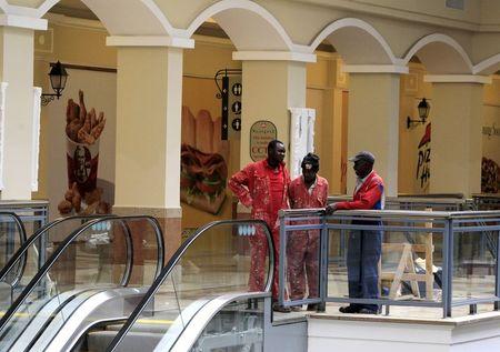 Workers stand in a section of the reopened Westgate shopping mall, which was closed in the aftermath of an attack by militant gunmen in September 2013 that killed 67 people and injured many more, in capital Nairobi, July 14, 2015. PHOTO BY REUTERS/Noor Khamis