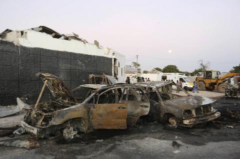 The wreckage of destroyed cars is seen at the scene of an explosion in Waabari district of Somalia's capital Mogadishu, January 4, 2015. PHOTO BY REUTERS/Feisal Omar
