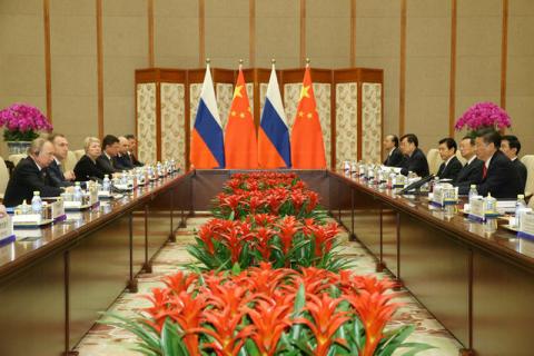 Chinese President Xi Jinping (R) speaks with Russian President Vladimir Putin (L) during a bilateral meeting at Diaoyutai State Guesthouse in Beijing, China, 14 May 2017. PHOTO BY REUTERS/Wu Hong