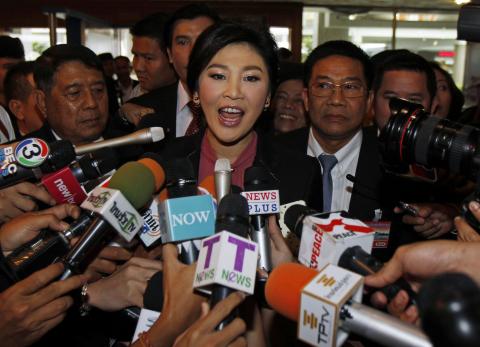 Ousted former Prime Minister Yingluck Shinawatra speaks to the media as she arrives at Parliament before the National Legislative Assembly meeting in Bangkok, January 9, 2015. PHOTO BY REUTERS/Chaiwat Subprasom