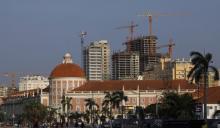 Office buildings under construction stand behind the Angolan central bank building in the capital, Luanda. PHOTO BY REUTERS/Mike Hutchings