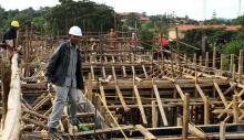 A construction worker checks on site progress of a new hospital in Hoima town, Uganda April 27, 2015. PHOTO BY REUTERS/James Akena