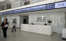 People walk near the reception at the Johannesburg Stock Exchange (JSE) in Sandton, Johannesburg, South Africa, December 10, 2015. PHOTO BY REUTERS/Siphiwe Sibek