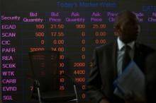 A man stands in front of an electronic board displaying market data at the Nairobi Securities Exchange in Nairobi, Kenya, April 11, 2017. PHOTO BY REUTERS/Baz Ratner
