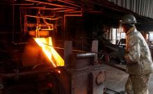 An employee works at a platinum smelter at Selous Metallurgical Complex near Harare, Zimbabwe, November 28, 2013. PHOTO BY REUTERS/Philimon Bulawayo