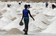 A woman walks across salt flats being cultivated for the white crystals near the village of Ngaye-Ngaye, 10 kilometers (six miles) south of Senegal's northern town of Saint Louis. PHOTO BY REUTERS/Finbarr O'Reilly