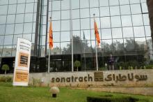 An employee stands near the headquarter of the state energy company Sonatrach in Algiers, Algeria, june 26, 2016. PHOTO BY REUTERS/Ramzi Boudia