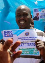 Somali journalist Abdimalik Muse Oldon holds a sign during a demonstration in support of the newly elected Somali President Mohamed Abdullahi Mohamed in Mogadishu, Somalia, February 9, 2017. PHOTO BY REUTERS/Feisal Omar