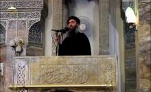 A man purported to be the reclusive leader of the militant Islamic State Abu Bakr al-Baghdadi making what would have been his first public appearance, at a mosque in the centre of Iraq's second city, Mosul, according to a video recording posted on the Internet on July 5, 2014, in this still image taken from video. PHOTO BY REUTERS/REUTERS/Social Media Website