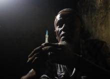 A heroin addict prepares heroin before using it in Lamu November 21, 2014. PHOTO BY REUTERS/Goran Tomasevic