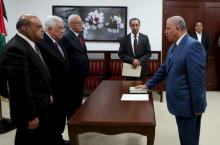Adnan Abu Laila, a member of the Palestinian constitutional court, is sworn in by President Mahmoud Abbas (2nd L) in the West Bank city of Ramallah, April 11, 2016. PHOTO BY REUTERS/Palestinian President Office (PPO)