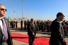 Algerian Prime Minister Ahmed Ouyahia (L) walks with Algeria's Senate President Abdelkader Bensalah before the arrival of French President Emmanuel Macron at Houari Boumediene airport in Algiers, Algeria, December 6, 2017. PHOTO BY REUTERS/Zohra Bensemra