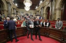 Catalan President Quim Torra (R) and deputy Albert Batet leave the chamber after the vote on whether former Catalan President Carles Puigdemont and other members of his government can keep their seats as lawmakers while being under investigation or in prison on charges of rebellion, at Catalonian regional Parliament in Barcelona, Spain, October 2, 2018. PHOTO BY REUTERS/Albert Gea