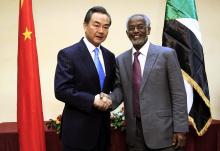 Sudan's Foreign Minister Ali Karti (R) shakes hands with China's Foreign Minister Wang Yi upon his arrival for a visit in Khartoum, January 11, 2015. PHOTO BY REUTERS/ Mohamed Nureldin Abdallah
