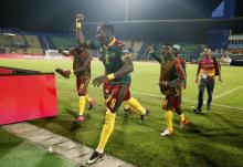 Cameroon's Ambroise Oyongo celebrates after the match with teammates. PHOTO BY REUTERS/Amr Abdallah Dalsh Livepic
