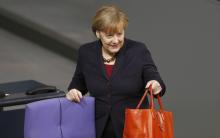 German Chancellor Angela Merkel arives for a session of the Bundestag in Berlin, December 18, 2014. PHOTO BY REUTERS/Hannibal Hanschke