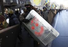 Anti-government protesters march on the street in Kiev