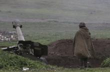An Armenian soldier of the self-defense army of Nagorno-Karabakh stands near an artillery unit in the town of Martakert, where clashes with Azeri forces are taking place, in Nagorno-Karabakh region, which is controlled by separatist Armenians, April 3, 2016. PHOTO BY REUTERS/Vahram Baghdasaryan