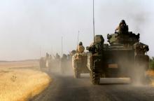 Turkish armoured personnel carriers are driven towards the border in Karkamis on the Turkish-Syrian border in the southeastern Gaziantep province, Turkey, August 27, 2016. REUTERS/Umit Bektas