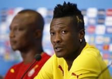 Ghana national soccer team captain Asamoah Gyan (R) speaks next to team coach James Kwesi Appiah during a news conference before their training session at the Dunas Arena soccer stadium in Natal June 15, 2014. Ghana will face United States on June 16. PHOTO BY REUTERS/Toru Hanai